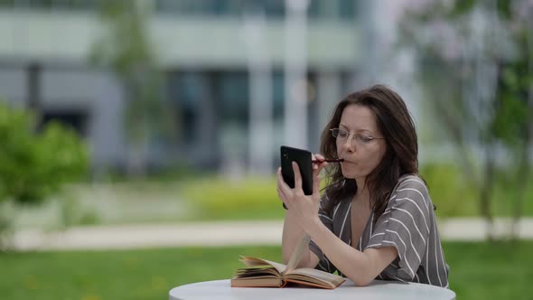 Business Lady Student Studying Science in City Park with Phone and Book