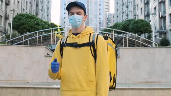 Young Courier Man Showing Thumb Up Gesture and Smiling While Wearing Face Mask for Coronavirus