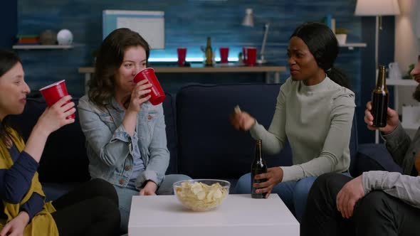 Mixed Race Friends Cheering Bottles of Beer Enjoying Time Spend Together