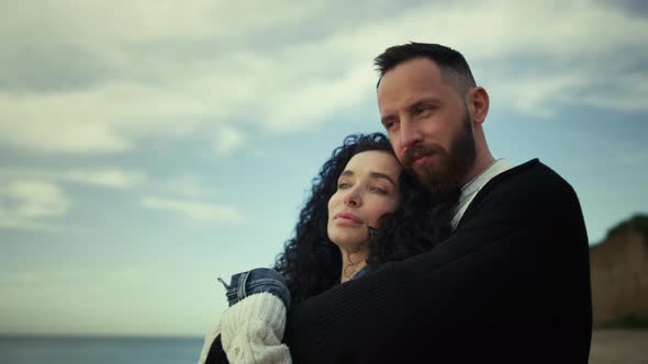 Relaxed Couple Cuddling Together on Beach Vacation