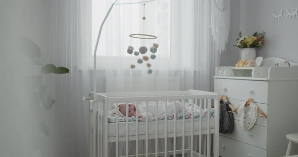 Cute Newborn Toddler Baby Lying in the Cradle in the Bright Modern Bedroom