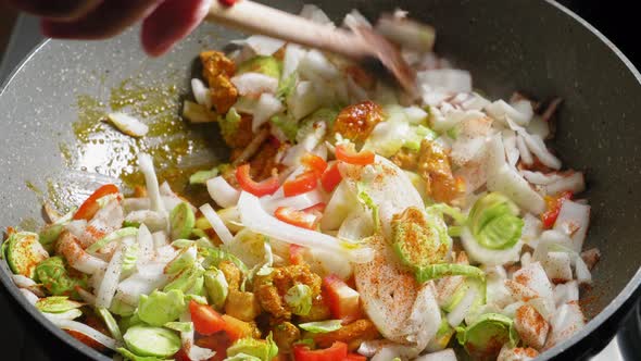 Cooking And Stirring Chopped Vegetables And Chicken Breast Seasoned With Spices. close up