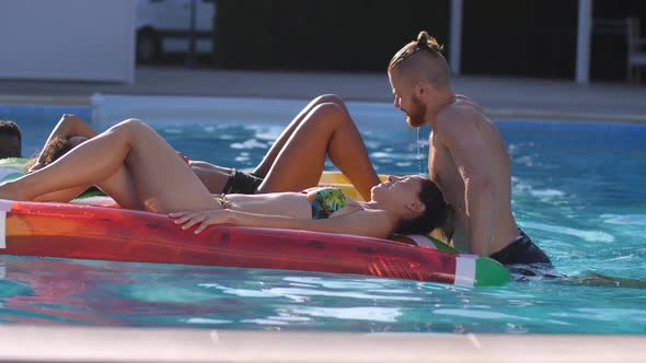 Playful Diverse Friends Relaxing in Swimming Pool