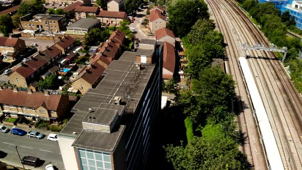 Train tracks withing train from above in the outskirts of London. Summer. Drone footage.