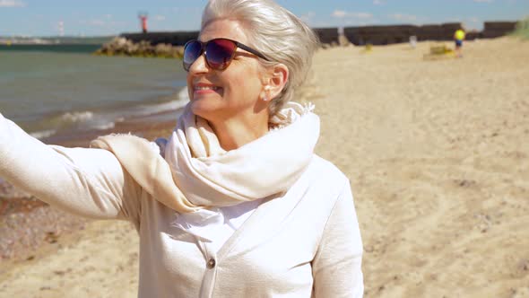 Senior Woman Taking Selfie By Smartphone on Beach