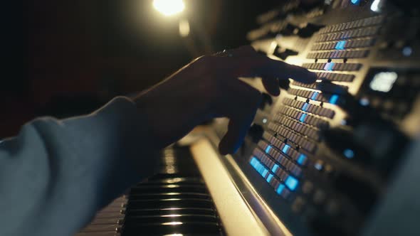 Hands of a Man Sound Engineer are Pressing Buttons on the Console