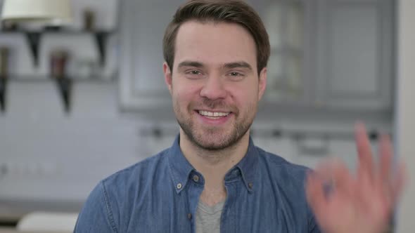 Portrait of Beard Young Man Showing Ok Sign