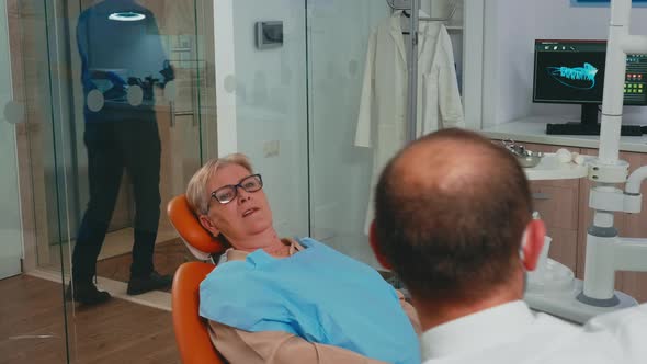 Woman with New Dental Implants Looking in the Mirror