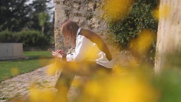 Allergic Woman Sneezing While Relaxing in the Park Near Blooming Flowers