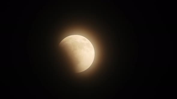 Glowing Waxing Gibbous Moon Isolated In Black Night Sky Background with clouds