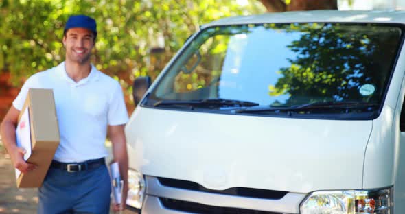 Delivery man carrying a parcel