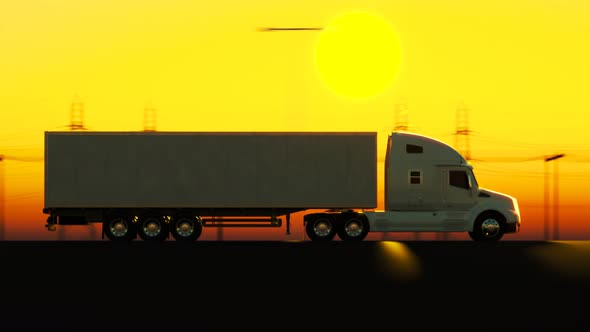 Silhouette of the semi truck with trailer driving on the street during dusk.