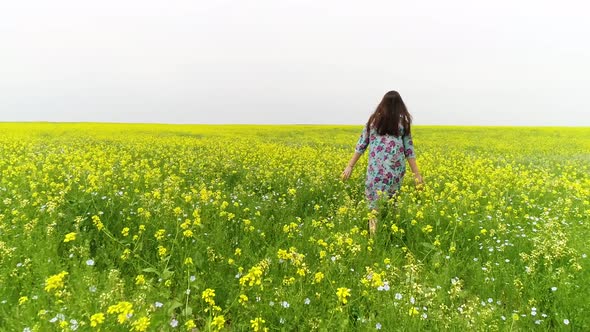a young girl walks in a flower field