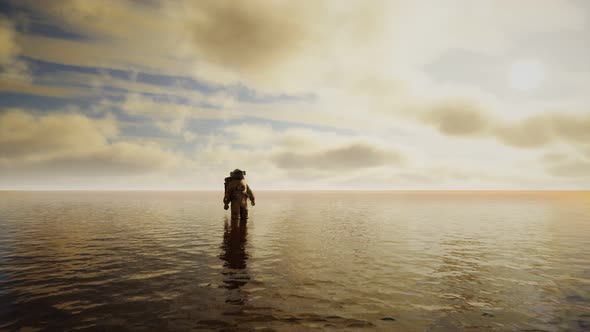 Spaceman in the Sea Under Clouds at Sunset