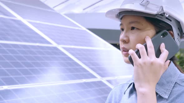 Close up, Asian female engineer working outdoors, making telephone call, talking