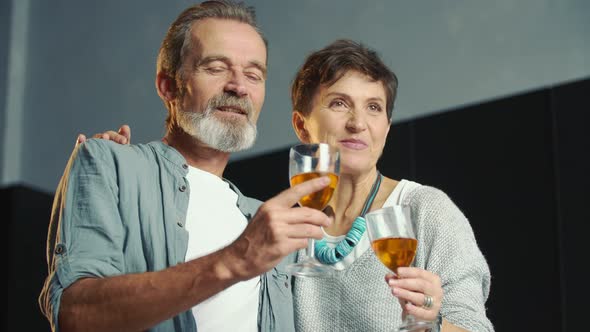 Couple in Ages with Glasses of Wine