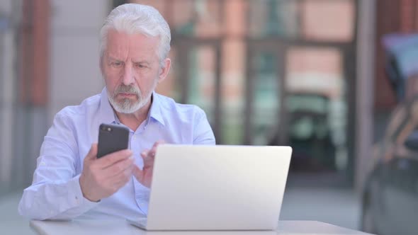 Outdoor Old Man Using Smartphone and Laptop