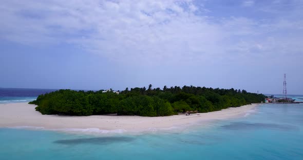 Daytime aerial travel shot of a white sandy paradise beach and blue water background 