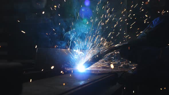 Closeup Welding of a Metal Part in a Garage or Auto Repair Shop Slow Motion