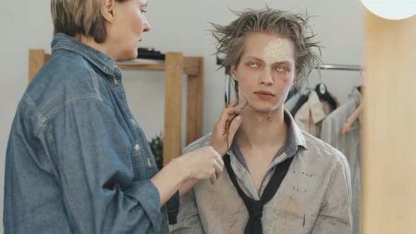 Woman Applying SFX Makeup on Man