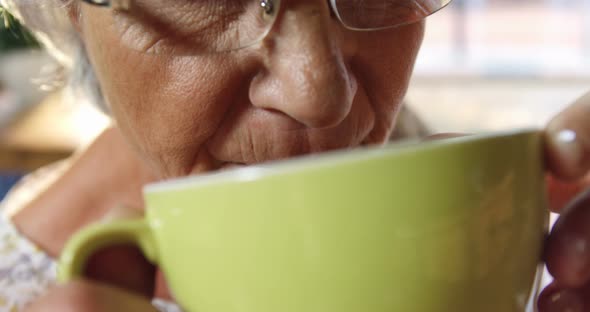 Senior woman drinking coffee in cafe 4k