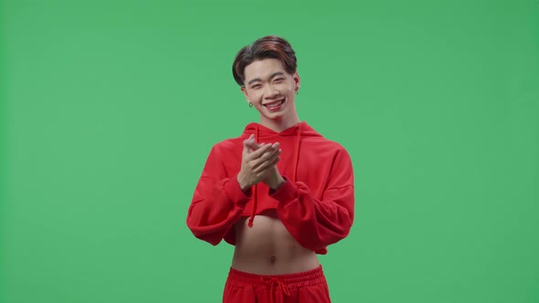 Young Asian Transgender Male Clapping Her Hands In The Green Screen Studio