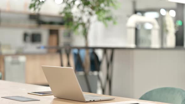 Middle Aged Man Leaving Laptop and Going Away in Office 