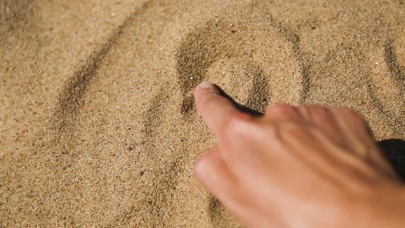 Drawing a heart on the sand with your finger is a sign of love for a beach holiday