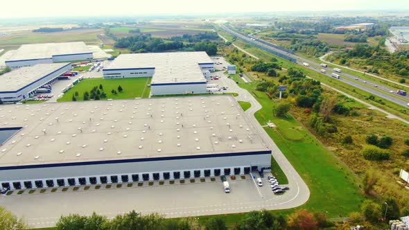 Aerial view of logistics center, warehouses near the highway. Delivery center Traffic