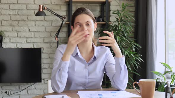 Happy beautiful woman blogger looking talking to camera. Pretty girl recording vlog at home, smiling