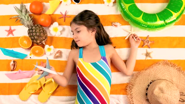 Children Sisters Sunbathe on the Beach