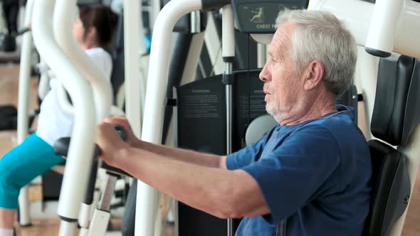 Elderly Male Person Training at Gym.