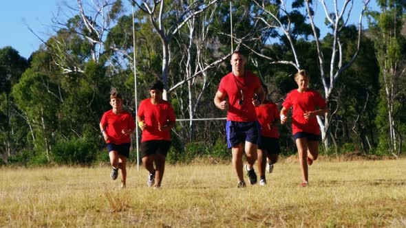 Trainer training kids in the boot camp