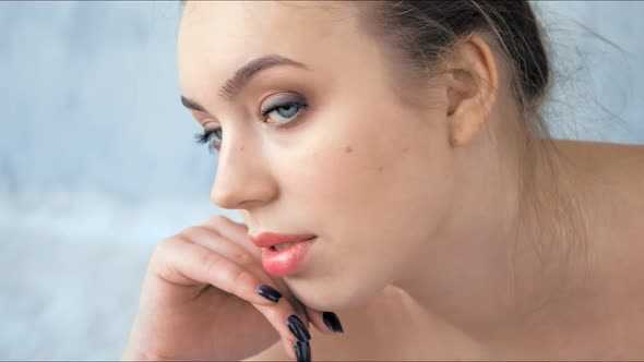 Closeup of Fashion Young Woman with Clean and Healthy Skin in Studio