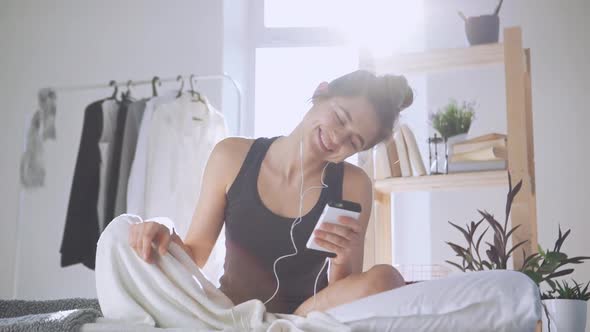 Caucasian Girl Listening Music Through Headphones and Smartphone in Slowmotion