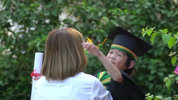 Asian Mother Embracing Her Son On Graduation Day