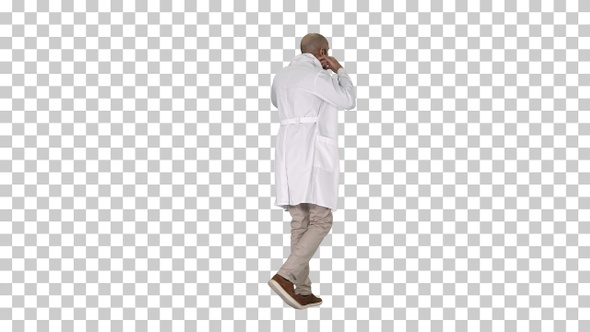 Walking doctor putting white robe on, Alpha Channel