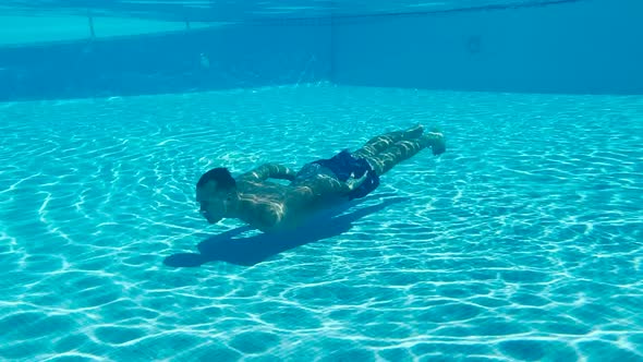 Beautiful Man Swimming Underwater Slow Motion