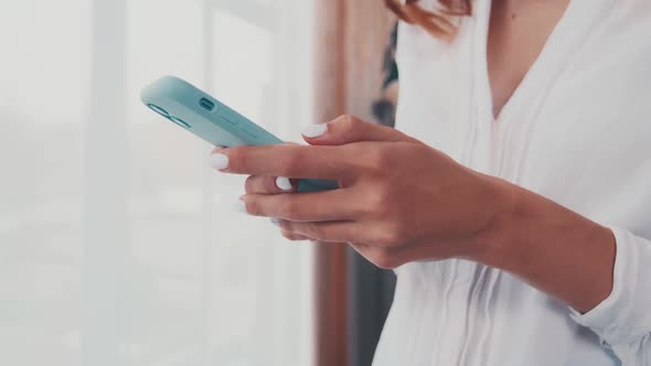 Close Up of Female Hands User Browse Web on Modern Smartphone Gadget