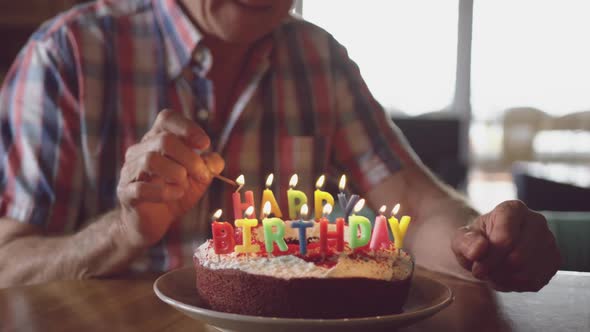 Senior man with a birthday cake at home