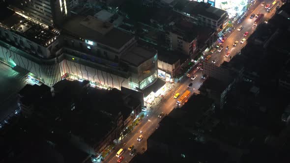 View from Above on The Traffic of A Night City. Cars Are Moving Along the Road. Business Center