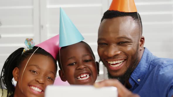 Family taking selfie at birthday party