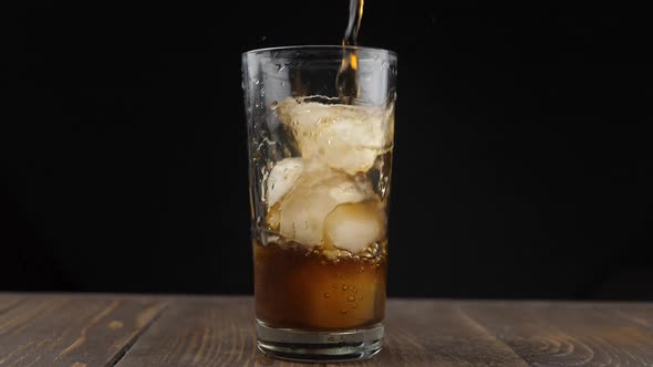 Pouring coke/cola/soda into a glass