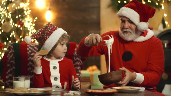 Merry Christmas and Happy New Year, Santa Grandfather with Little Kid Boy Baking Xmas Cookies 