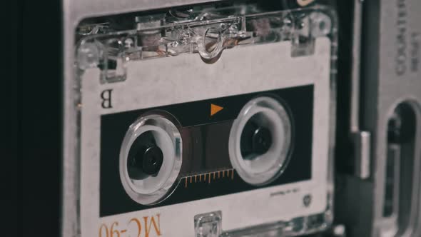 Audio Cassette in the Tape Recorder Playing and Rotates