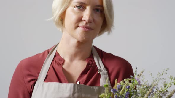 Experienced Blonde Florist Posing With Bouquet