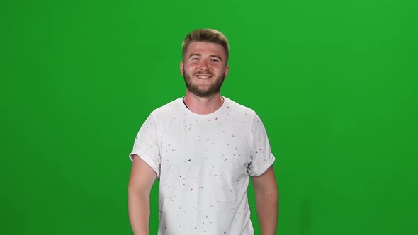 Portrait of Bearded Guy Calmly Walking on Green Screen.  Chroma Key. Front View. Slow Motion