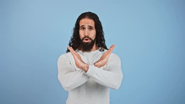 Young Skeptical Italian Man with Crossed Hands Showing Stop Gesture Shaking Head No Renouncement and