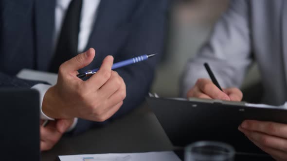 Businessman Hands Writing Document Analysing Corporate Report in Company Office