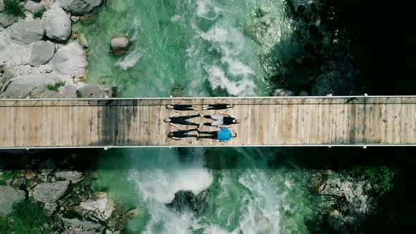 Aerial view of people lying on bridge over Soca river in Slovenia.